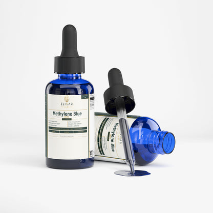 A blue glass dropper bottle labeled Elisa Methylene Blue stands upright, with a second bottle lying on its side and a glass dropper resting across it on a white studio background.