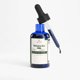 A blue glass dropper bottle labeled 'ELILAR Methylene Blue' with a black dropper cap and a glass pipette filled with blue liquid, shown on a clean white background.